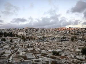 City of Hebron in the occupied West Bank shows a view of a Palestinian cemetery (foreground), an old market building (C) along al-Shuhada street that was newly-announced by the Israeli defence minister to be designated as a new settlement, with existing Israeli settler buildings behind (AFP) 