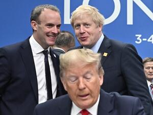 Britain's Foreign Secretary and First Secretary of State Dominic Raab (top L) and Britain's Prime Minister Boris Johnson talk by US President Donald Trump during the plenary session of the NATO summit at the Grove hotel in Watford, northeast of London on December 4, 2019. Tobias SCHWARZ / AFP