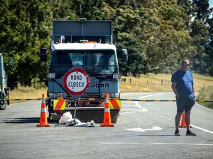 This photo taken on December 8, 2019 shows an official standing in front of a road block after the Rakaia River rose to dangerous levels, near the town of Geraldine on New Zealand's South Island. (AFP/ File Photo)