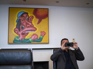 David Datuna, the performance artist who ate a banana Saturday afternoon in Miami at Art Basel, take a picture of media during a press conference on December 9, 2019 in New York. The move was bananas... or maybe the work was just too appealing. AFP