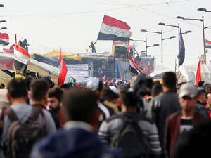 Iraqis gather at al-Sinek bridge in the capital Baghdad amid ongoing anti-government protests on December 10, 2019. SABAH ARAR / AFP