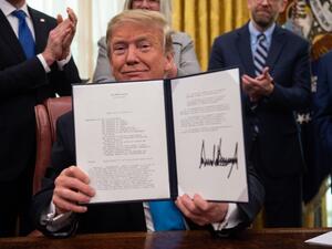 In this file photo taken on February 19, 2019, US President Donald Trump shows his signature on the Space Policy Directive-4 (SPD-4) at the White House in Washington, DC (AFP)