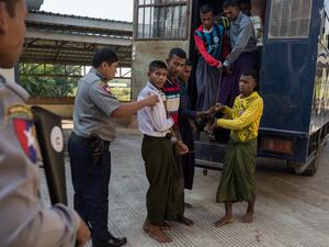 Rohingya detainees step out of a police van upon arriving at the court in the western Myanmar city of Pathein ahead of a hearing on December 11, 2019. (AFP/ File Photo)