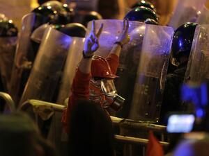 A Lebanese protester wearing protective gear flashes the victory sign at security forces, amid clashes which erupted during an anti-government demonstration in the downtown area of the capital Beirut on December 15, 2019.  (AFP/ File Photo)