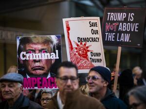 Protesters hold signs during a demonstration in part of a national impeachment rally, at the Federal Building in San Francisco, California on December 17, 2019. Protesters around the nation participated in "Nobody is Above the Law" rallies on the eve of a historic Trump impeachment vote in the United States House of Representatives. Philip Pacheco / AFP