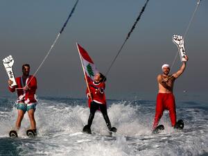 Members of a Lebanese water sports club dressed an Santa Claus (AFP)