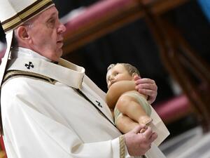 Pope Francis carries a statue of baby Jesus during a mass on Christmas eve marking the birth of Jesus Christ on December 24, 2019, in St Peter's basilica at the Vatican. Alberto PIZZOLI / AFP
