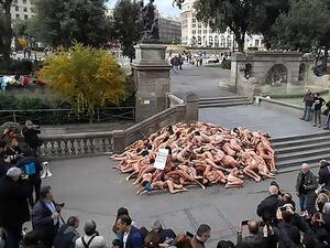 The protest consisted of dozens of activists lying on the ground while covered in fake blood as a sitting woman holding a sign shouted out 'suffering is not elegant'. (CEN/ AnimaNaturalis)