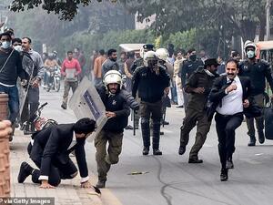 Policemen chase lawyers following a clash between lawyers and doctors in Lahore today (AFP/ File Photo)
