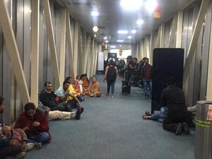 Passengers shared on social media photos of passengers sitting on the floor of the aerobridge. (Twitter)