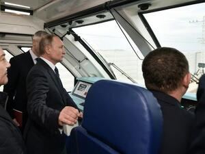 President Vladimir Putin stood in the driver's cabin of a train for the official opening of a railway bridge that links annexed Crimea to southern Russia (Twitter)