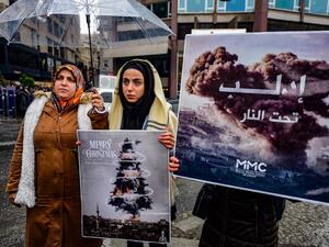 Protestors hold placards reading "bomb Christmas tree" during a protest against Syrian military operation in the rebel bastion of Idlib, northwestern Syria, taking place near the Russian Consulate, in Istanbul, on December 28, 2019.(AFP/ File Photo)