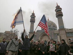 Iranians burn an Israeli and a US flag during an anti-US protest over the killings during a US air stike of Iranian military commander Qasem Soleimani and Iraqi paramilitary chief Abu Mahdi al-Muhandis, in the capital Tehran on January 4, 2020. ATTA KENARE / AFP