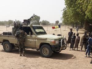 Soldiers of the Chad Army stand next to a Land Cruiser, while bystanders look on, before buing sheep at the Koundoul market, 25 km from N'Djamena, on January 3, 2020, upon their return after a months-long mission fighting Boko Haram in neighbouring Nigeria. (AFP/ File Photo)