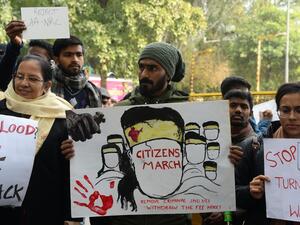 Protesters hold placards at a demonstration against India's new citizenship law in New Delhi on January 9, 2020. Sajjad HUSSAIN / AFP