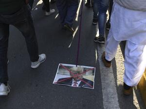 A Muslim protester drags a placard of US president Donald Trump during a protest against the US military action for the killing of the top Iranian general Qasem Soleimani in Iraq, during a demonstration in New Delhi on January 12, 2020. Sajjad HUSSAIN / AFP