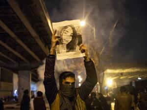 An Iranian man holds a picture of a victim of the Ukrainian Boeing 737-800 plane crash during a demonstration in front of Tehran's Amir Kabir University on January 11, 2020. Demonstrations broke out for a second night in a row after Iran admitted to having shot down a Ukrainian passenger jet by mistake on January 8, killing all 176 people on board. STR / AFP