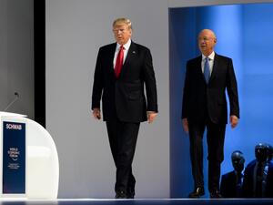 In this file photo taken on January 26, 2018, US President Donald Trump (L) arrives on stage followed by Founder and Executive Chairman of the World Economic Forum (WEF) Klaus Schwab before delivering his speech at the World Economic Forum (WEF) annual meeting in Davos, eastern Switzerland. (AFP)