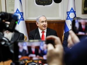 Israeli Prime Minister Benjamin Netanyahu is filmed by journalists as he attends the weekly cabinet meeting at his office in Jerusalem on January 19, 2020. GIL COHEN-MAGEN / POOL / AFP