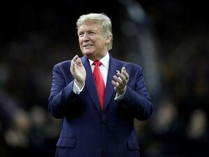 U.S. President Donald Trump claps prior to the College Football Playoff National Championship game between the Clemson Tigers and the LSU Tigers at Mercedes Benz Superdome on January 13, 2020 in New Orleans, Louisiana. Chris Graythen/Getty Images/AFP