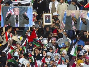 Pro-Palestinian protesters wave Palestinian and Moroccan flags next to posters of the US President Donald Trump and Israeli Prime Minister covered in shoes in a sign of disrespect during a demonstration in Rabat, Morocco on 10 December 2017 [FADEL SENNA/AFP/Getty Images]