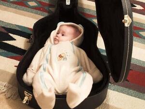A baby was placed into a guitar case as the 'playing Ghosn' craze swept Japan. The fugitive tycoon escaped the country inside an audio equipment case (Twitter)