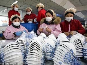 In the picture taken yesterday, workers are seen producing face masks at a factory in Handan in China's northern Hebei province. (AFP/ File Photo)