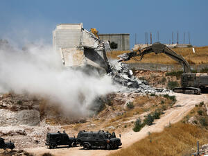 Israeli security forces tear down one of the Palestinian buildings still under construction. AHMAD GHARABLI/AFP