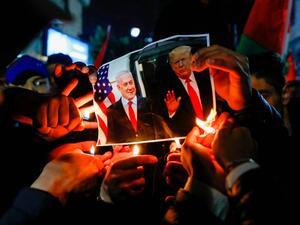 Palestinian protesters burn pictures of US President Donald Trump and Israel's Prime Minister Benjamin Netanyahu during a demonstration in the West Bank against the expected peace plan proposal AFP via Getty