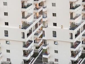 The child jumps as she appears to lose her footing (pictured) and races back along the ridge, before stopping at the window where the footage ends. (Facebook)