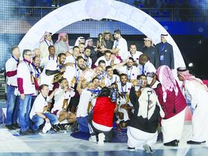  HE Sheikh Joaan bin Hamad al-Thani, the president of the Qatar Olympic Committee, poses with Qatar Handball Association president Ahmed Mohamed al-Shabi and members of the Qatar national team after they won the Asian Handball Championship.