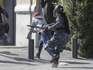 Anti-government protesters throw stones during clashes with security forces amidst a demonstration in the centre of the Lebanese capital Beirut on January 27, 2020. JOSEPH EID / AFP