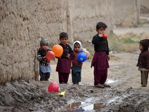 Children play with balloons along a street in Kandahar Province on January 28, 2020. JAVED TANVEER / AFP
