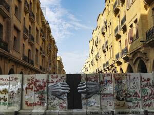 This picture taken on January 28, 2020 shows a view of a graffiti-covered concrete barrier erected by Lebanese security forces separating Riad al-Solh square from the parliament headquarters in the capital Beirut's central downtown district. JOSEPH EID / AFP