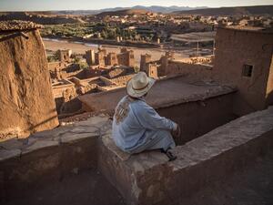 A man sits atop the Kasbah (ancient fortress) of Ait-Ben-Haddou, where scenes depicting the fictional city of Yunkai from the hit HBO television series "Game of Thrones" were filmed, about 32 kilometres northwest of the city of Ouarzazate south of Morocco's High Atlas mountains on January 27, 2020. AFP