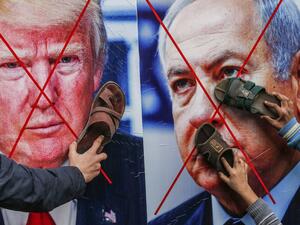 Palestinian protesters stick their footwear on posters depicting the faces of (L to R) US President Donald Trump and Israeli Prime Minister Benjamin Netanyahu during a demonstration against Trump's Middle East peace proposal in Khan Yunis in the southern Gaza Strip on February 3, 2020. SAID KHATIB / AFP