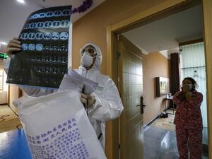 This photo taken on February 3, 2020 shows a doctor looking at a lung CT image while making his rounds at a ward of a quarantine zone in Wuhan, the epicentre of the new coronavirus outbreak, in China's central Hubei province. AFP