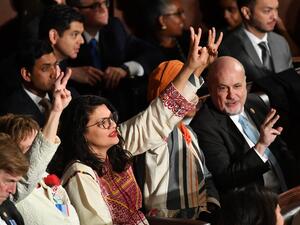 Representative for Minnesota Ilhan Omar (R) and Representative for Michigan Rashida Tlaib (L) gesture as US President Donald Trump delivers the State of the Union address at the US Capitol in Washington, DC, on February 4, 2020.  MANDEL NGAN / AFP