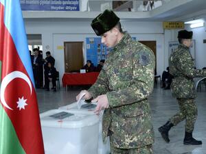 Azerbaijan's servicemen vote at a polling station during the parliamentary elections in Baku on February 9, 2020. Azerbaijan on Sunday holds snap parliamentary elections denounced by opposition parties as a feint aimed at further strengthening authoritarian President Ilham Aliyev's tight grip on power. TOFIK BABAYEV / AFP
