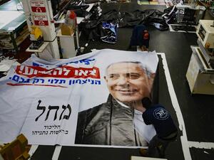Israeli workers prepare an election banner for the Likud party showing the face of its leader Israeli Prime Minister Benjamin Netanyahu, at a printing factory in the central Israeli city of Petah Tikva, on February 20, 2020. JACK GUEZ / AFP