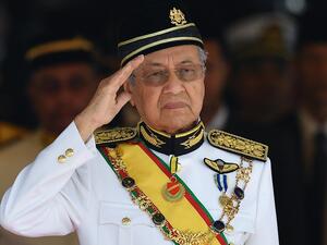 In this file photo taken on July 17, 2018, Malaysia's Prime Minister Mahathir Mohamad salutes the royal guard of honour during the opening ceremony of the parliament in Kuala Lumpur. Malaysian Prime Minister Mahathir Mohamad, at 94 the world's oldest leader, submitted his resignation to the king on February 24, 2020, his office said, after a bid by his political partners to bring down the government. Mohd RASFAN / AFP