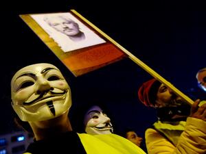 Demonstrators sporting Guy Fawkes masks take part in a protest called by Catalan National Assembly (ANC) under the motto "Journalism is not a crime" to support WikiLeaks founder Julian Assange in Barcelona on February 24, 2020. LLUIS GENE / AFP