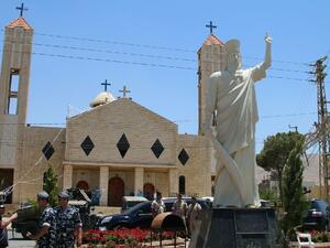 Lebanese soldiers stand guard in front of a church where a suicide bomber blew himself up the previous day in the Christian village of Al-Qaa, on June 28, 2016 (AFP Photo/)