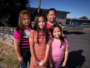 Beth and Ronne and their daughters Joyce, 11, and Jasmine, 7, who were forced out of class over coronavirus fears  (DAILYMAIL)