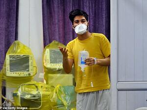 An Iranian student who is feared to be the first coronavirus patient in Iraq wears a mask and holds medical equipment at a hospital in Najaf in Iraq yesterday. AFP/File