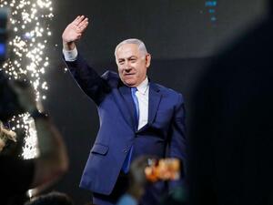 Israeli Prime Minister Benjamin Netanyahu greets supporters at his Likud Party headquarters in the Israeli coastal city of Tel Aviv on election night, early on April 10. (AFP)