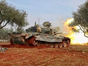 Syrian rebels fire from position in countryside of Idlib towards government forces on Sunday (AFP)
