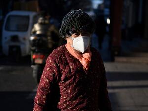 A woman wears a face mask as a preventive measure against the COVID-19 coronavirus (AFP)