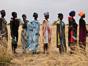 Women queue as they wait to receive food rations at a village in Ayod county, South Sudan, where World Food Programme (WFP) have just carried out a food drop of grain and supplementary aid on February 6, 2020. The villagers hear the distant roar of jet engines before a cargo plane makes a deafening pass over Mogok, dropping sacks of grain from its hold to the marooned dust bowl below. South Sudan is the last place on earth where food is airdropped, and in Mogok there was little other choice: without the ton