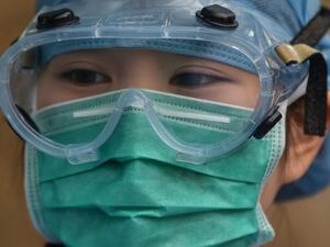 A medical worker wearing protective clothing as a preventive measure against the COVID-19 coronavirus, stands at Xuhui District Hospital in Shanghai on March 9, 2020 China reported 22 new deaths on March 9 from the new coronavirus epidemic, and the lowest number of fresh cases since it started reporting the data in January. Hector RETAMAL / AFP